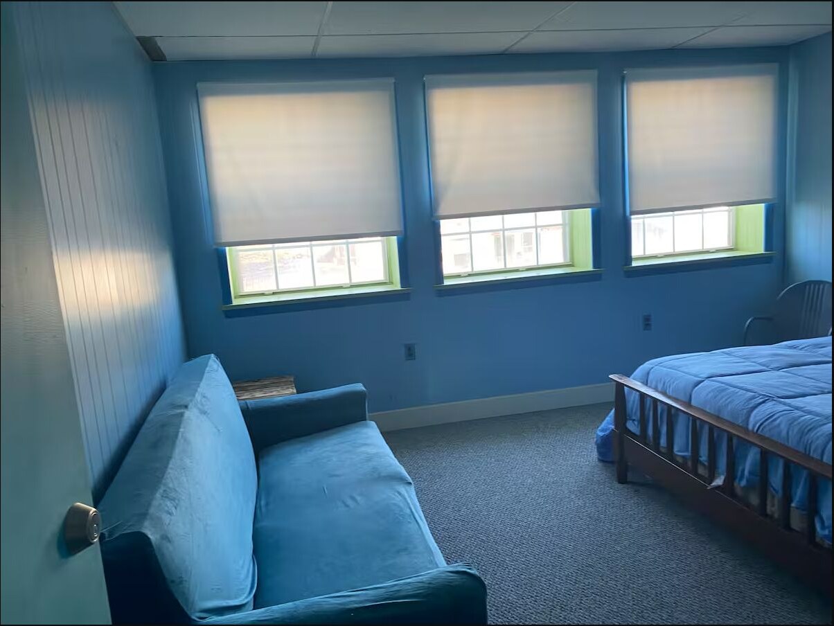 Cheerful green bedroom with a blue bedspread