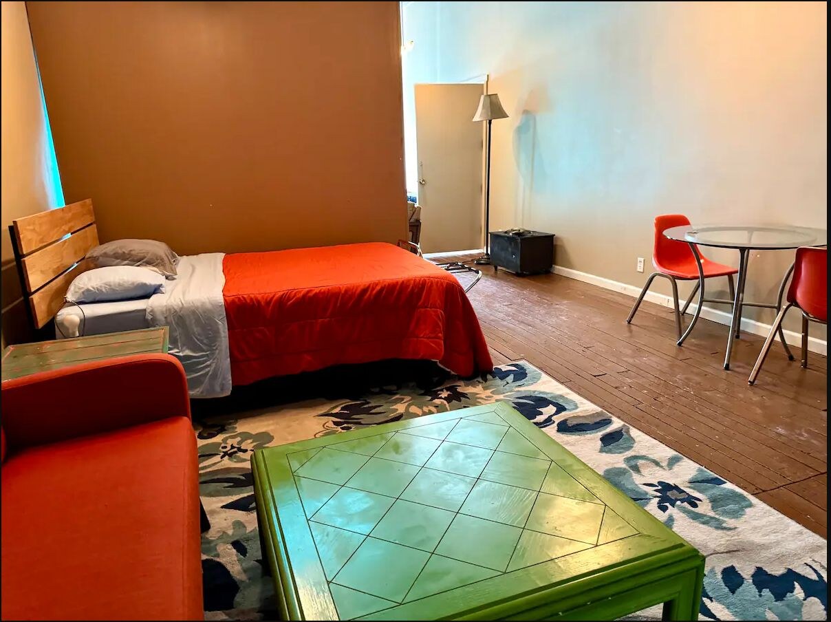 Second colorful living and sleeping area with turquoise accent wall