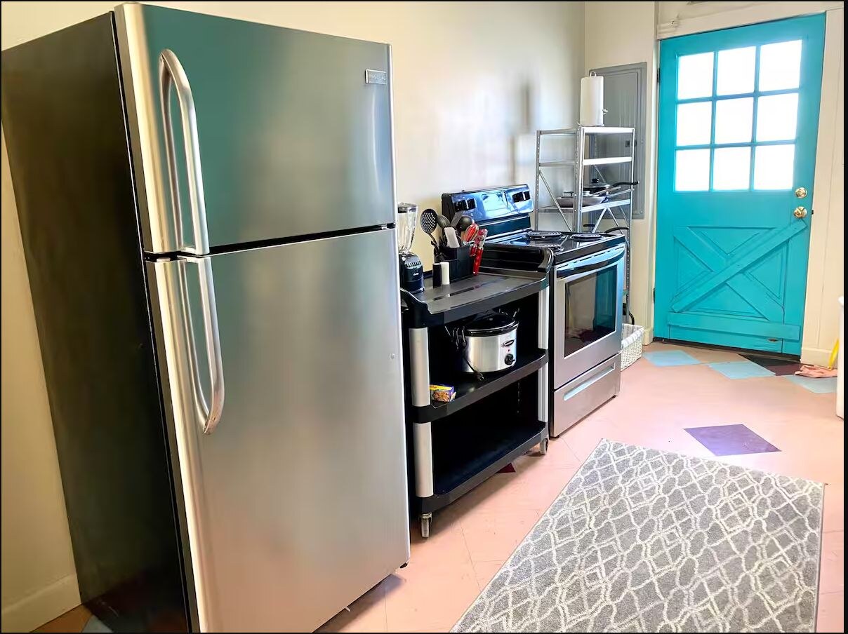 Full kitchen with stainless refrigerator and turquoise door