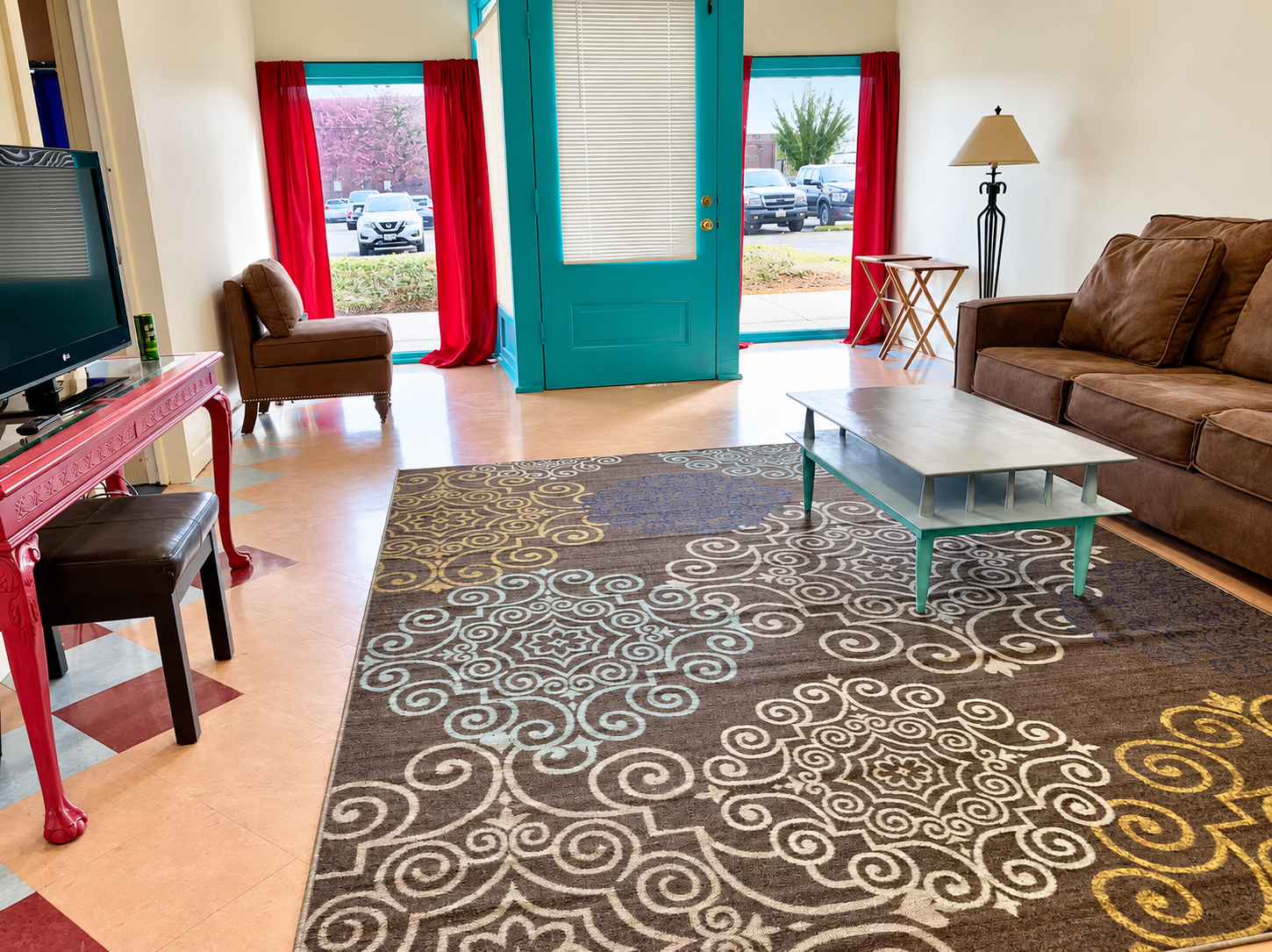 Colorful Dual Apartment living room with teal doors and red curtains