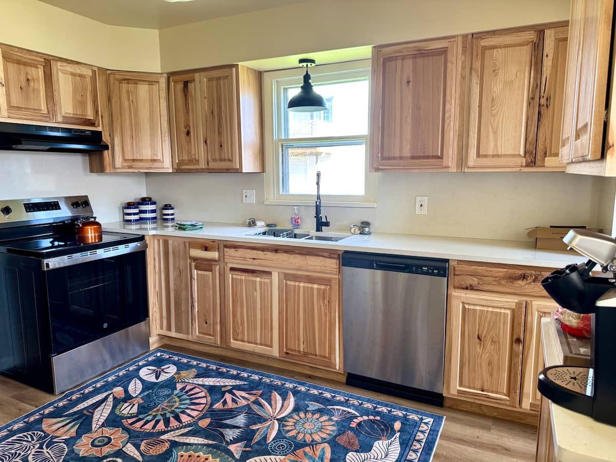 Updated kitchen with hickory cabinets and linen quartz counters