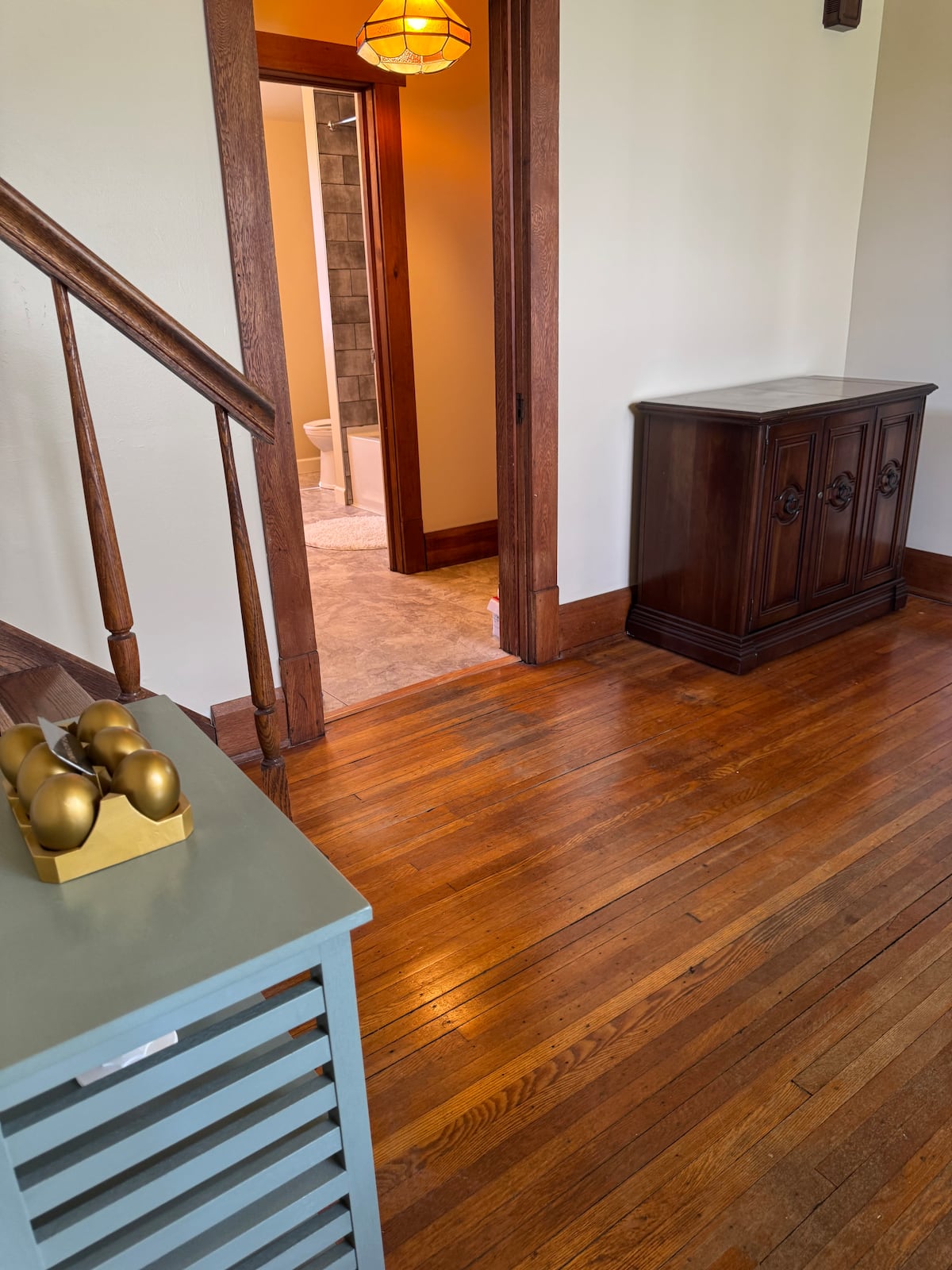 Original wood floors and doorway beside the staircase