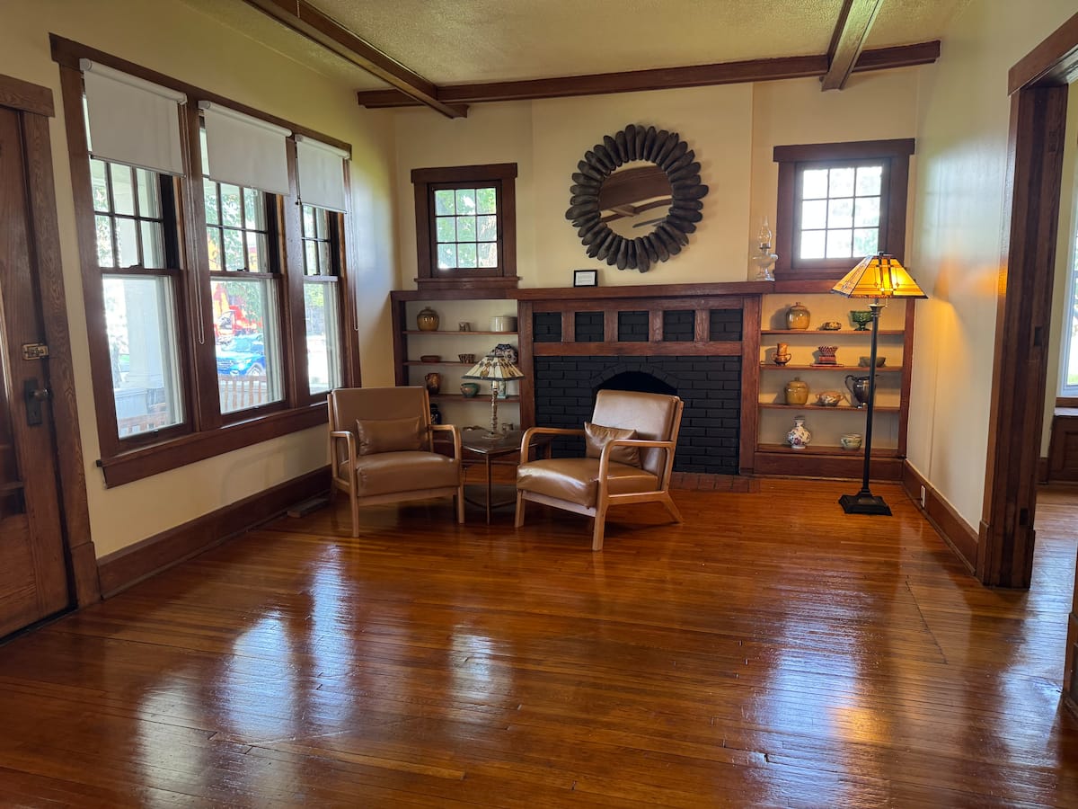 Second parlor with original fireplace and sunny windows