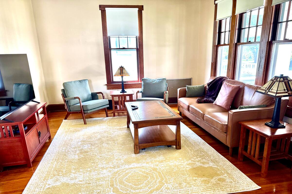 Main parlor with sofa, chairs and television