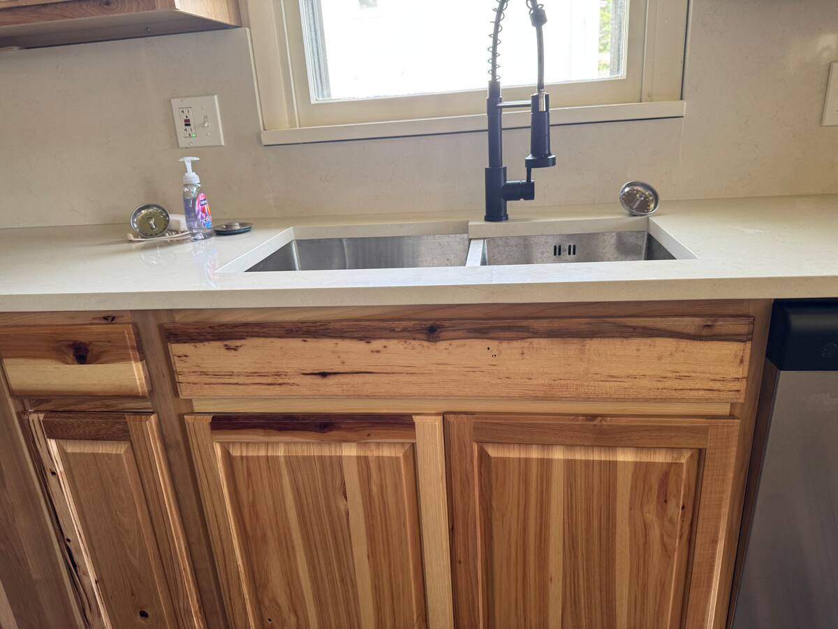 Kitchen sink beneath a sunny window