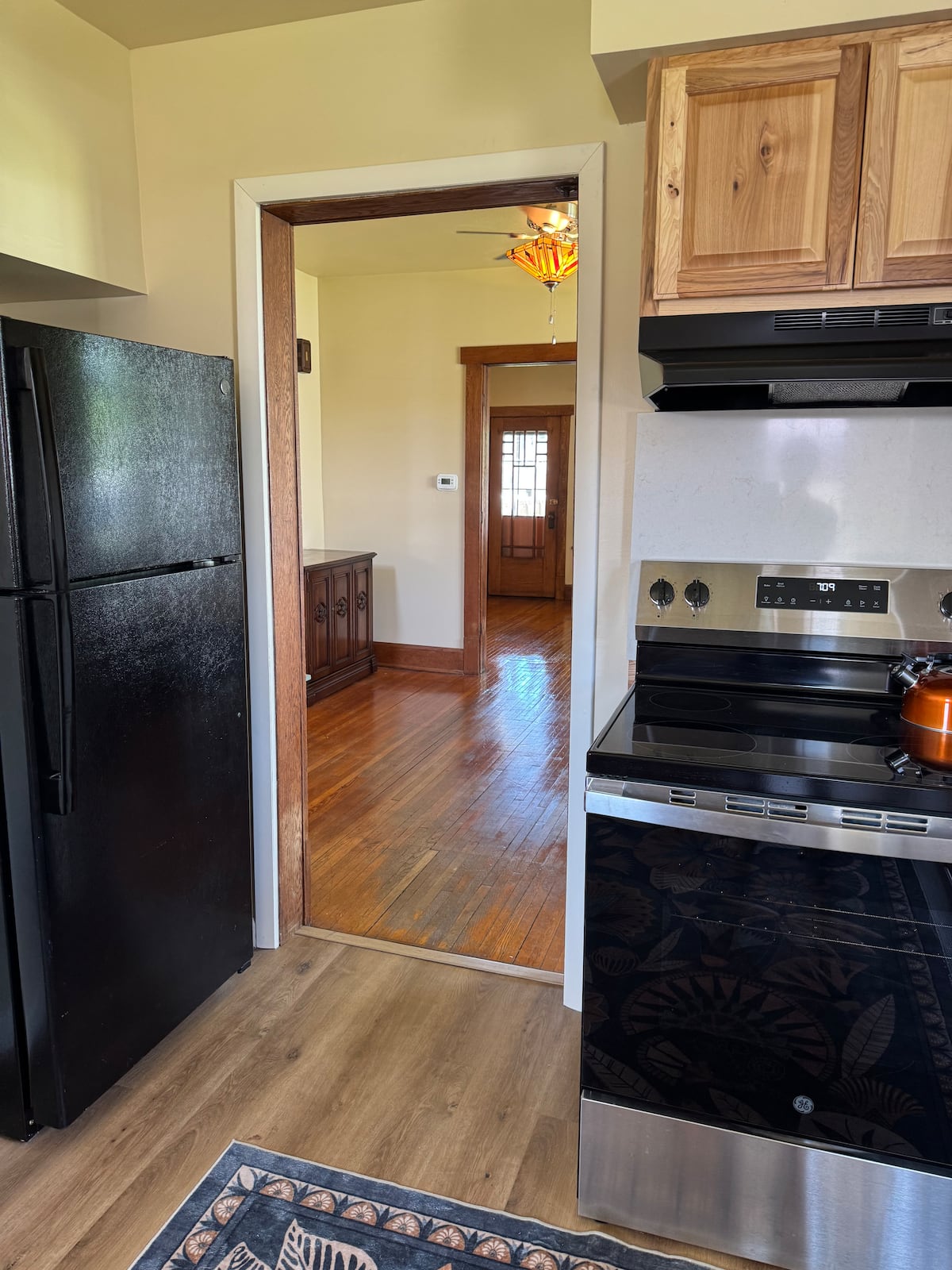 Kitchen with refrigerator and range