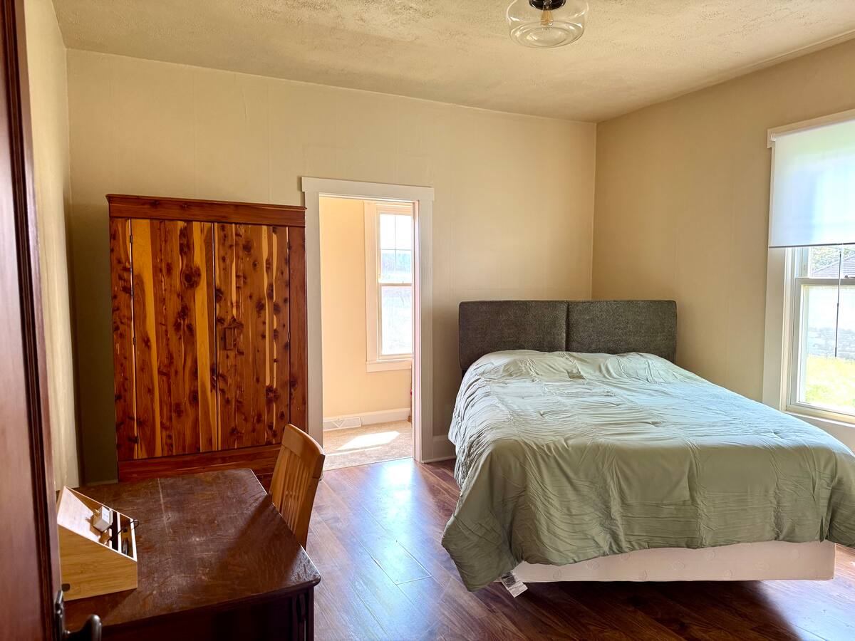Queen bedroom with windows on two sides